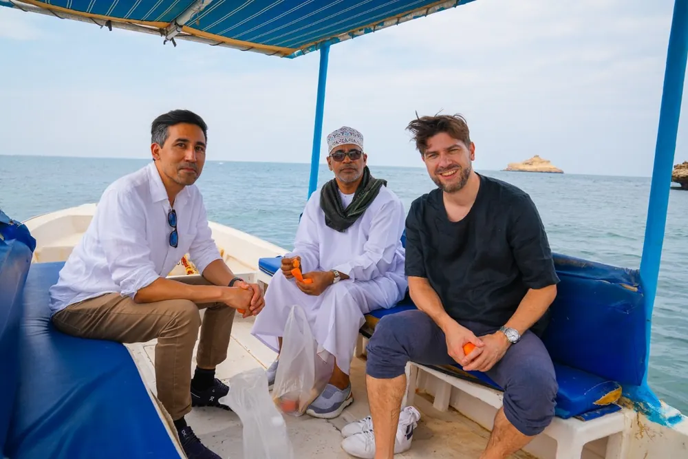 Three of the team on a boat with a partner