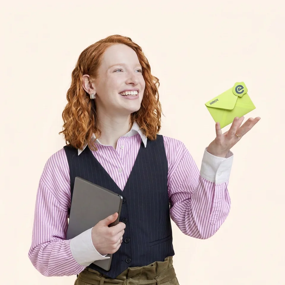 Someone smiling at a lime green envelope marked inbox.