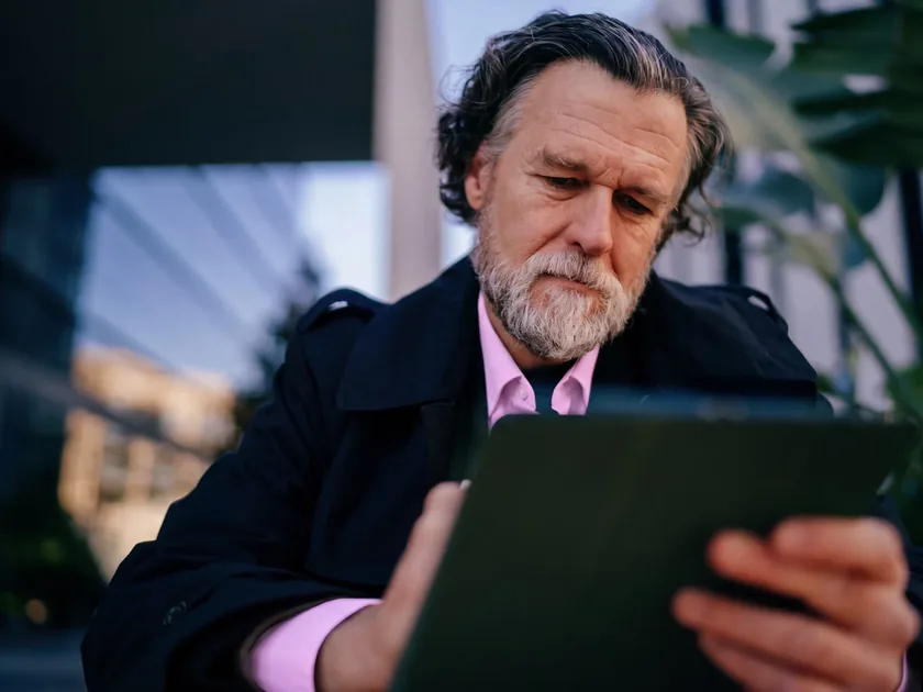 A senior colleague reviewing cohort results on a tablet.