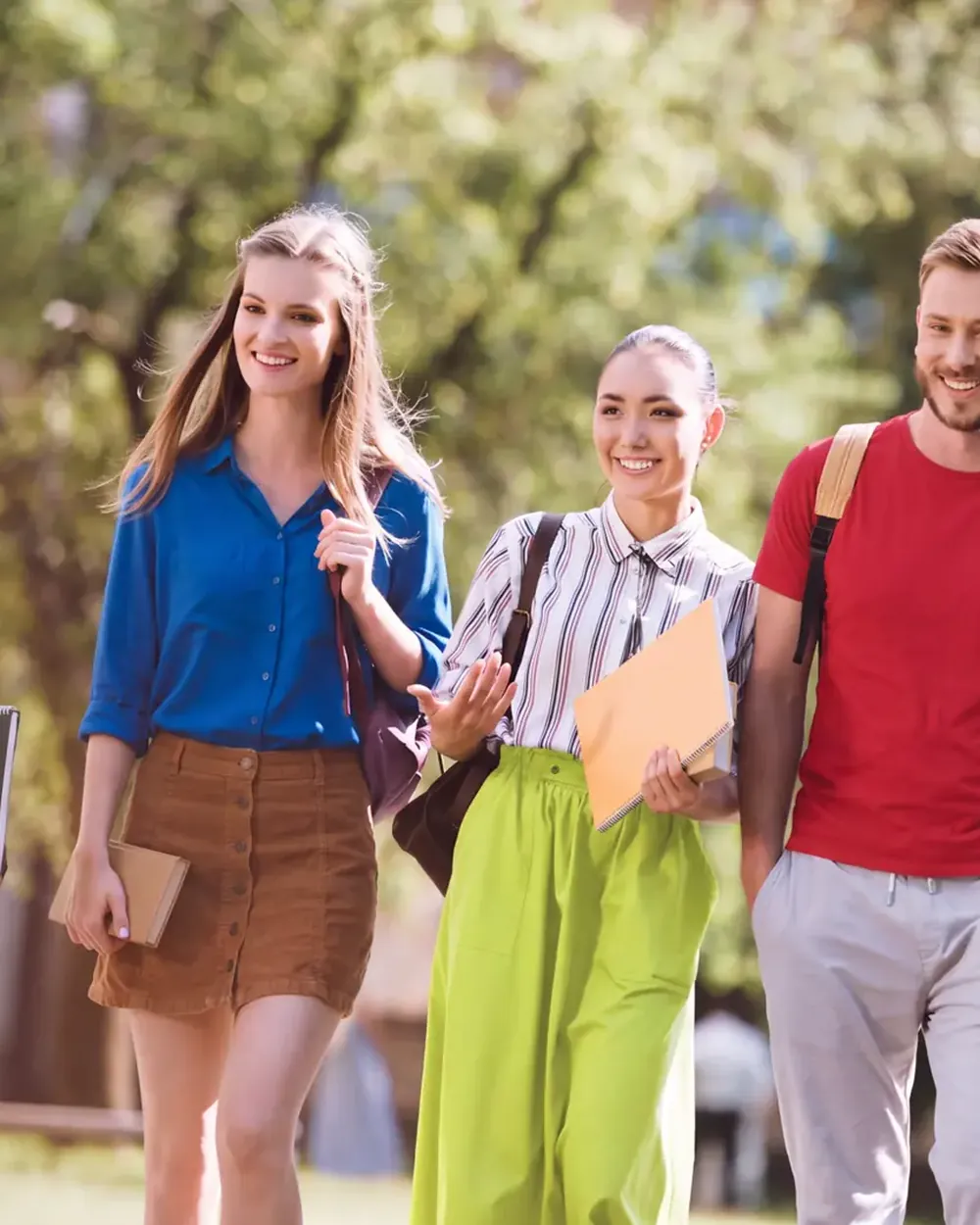 Four students walking across campus together.
